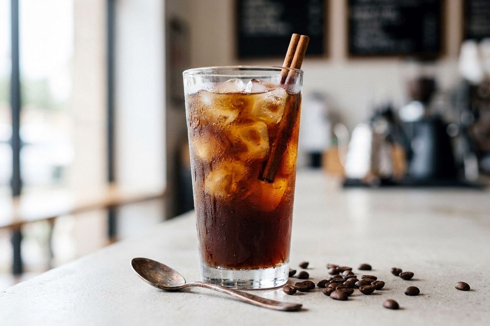 Glass of iced cold brew coffee with a cinnamon stick