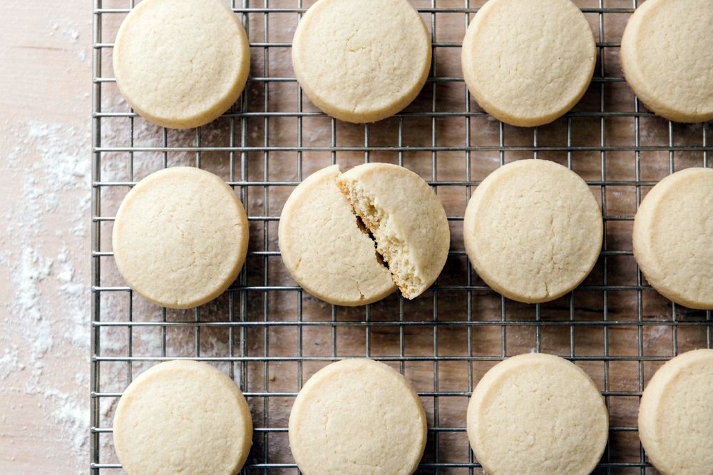 Round almond flour shortbread cookies cooling on a wire rack